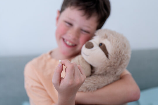 Young boy smiling with his first fallen milk tooth