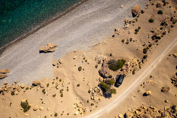 Aerial drone photo of black campervan wild camping at the roadside at a beach at Crete, Greece