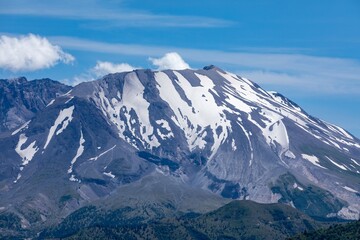 Majestic snow-capped mountain peak under a clear blue sky. Nature's grandeur.  Mount St. Helens National Volcanic Monument, Washington, USA