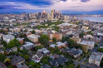 Seattle cityscape at twilight, showcasing a mix of high-rise buildings and residential...