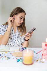 Modern Mystic Woman Practicing Divination with Candles and Tarot