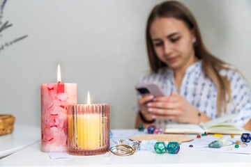 Modern Mystic Woman Practicing Divination with Candles and Tarot