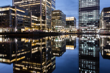 Reflections of corporate buildings in water, Canary Wharf, London