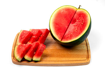 Fresh watermelon slices arranged on a wooden cutting board with a half-cut watermelon, isolated on...