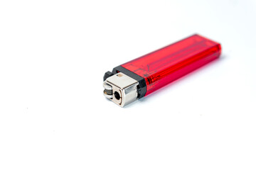 A close-up of a red lighter resting on a white background, highlighting its sleek design and functional features, ideal for various lighting needs.