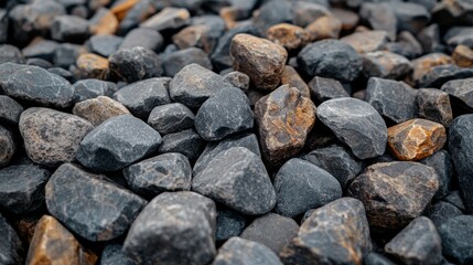 A grid of sixteen gray rocks, each featuring different textures and formations, is meticulously arranged on a black background
