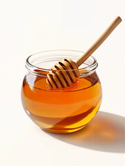 Honey in a glass jar with a wooden dipper resting on top, showcasing its rich color and texture for culinary use
