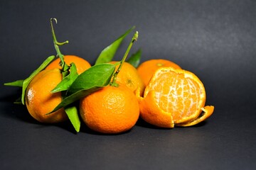 Group of fresh organic tangerines on a gray background 