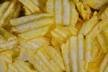 Close-up photo of unhealthy salty potato chips 