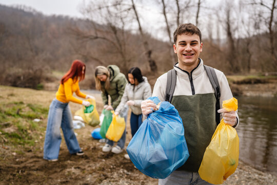portrait of young man activist volunteer hold waste garbage