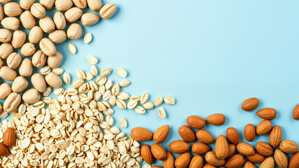 Top view of peanuts, oats, soybeans and almonds arranged in horizontal rows. Colorful display of healthy food ingredients.