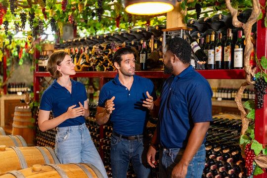 Winery and brewery business industry and wine tasting concept. Portrait of Diversity man and woman employee sommelier or wine steward working in wine shop or alcohol drink liquor store warehouse.