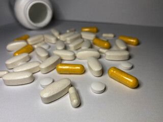 pills and capsules
Scattered tablets, vitamins from the jar.