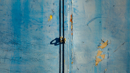 Turquoise blue and white painted background of an old iron gate