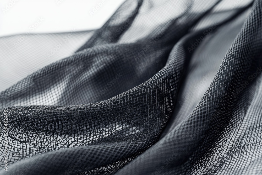 Aufkleber close-up of dark, textured fabric with a net-like pattern, creating a dramatic, elegant drape.