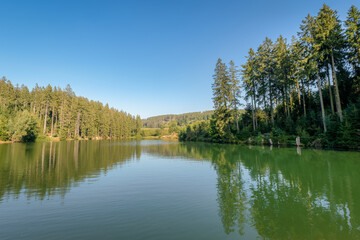 The circular walk in the Grumbach Valley, located in the Harz Mountains (Germany), runs along some ponds that are together called Grumbach Pond. It is an old mining reservoir or man-made lake.
