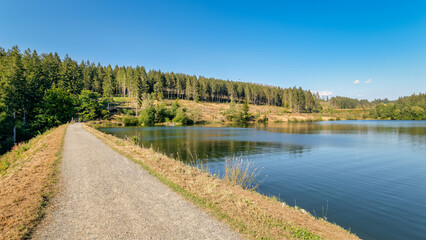 The circular walk in the Grumbach Valley, located in the Harz Mountains (Germany), runs along some ponds that are together called Grumbach Pond. It is an old mining reservoir or man-made lake.
