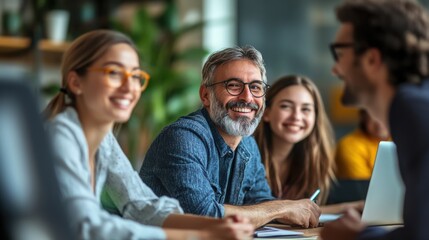Fototapeta premium Happy team works at the office. Group of people talk and smile. Diverse staff looks positive during meeting. Everyone sits by table.