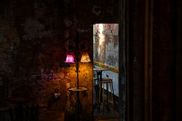Ruin bar interior in Budapest displaying colorful lamps and graffiti art