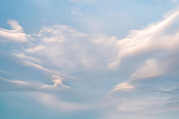 Tranquil blue sky with wispy white clouds at daybreak