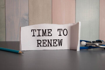 Time to renew words written on ripped red paper with yellow background.