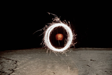 Fiery circle of life on black smoke backdrop. Round symbolism, fire sparks depict