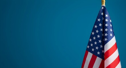 Fototapeta premium Photograph of an American flag on a blue background with copy space
