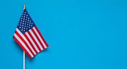 Obraz premium Photograph of an American flag on a blue background with copy space