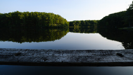 Glass like smooth surface reflections of sunset over Boley Lake in Wedst Virginia