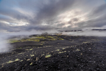 Breathtaking Landscape of Volcanic Terrain with Dramatic Clouds and Misty Atmosphere Captured in Majestic Icelandic Nature