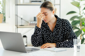 Sad exhausted stressed business woman, office secretary, sitting at the desk with eyes closed,...