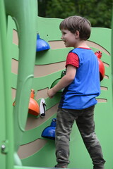 little boy playing on playground