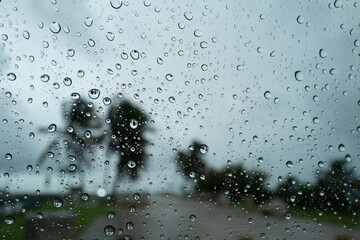 Rain drops on a automobile windshield  from Hurricane Milton in the Florida Keys at the pedestrian walkway of the old 7-Mile bridge on a cloudy, windy and stormy day