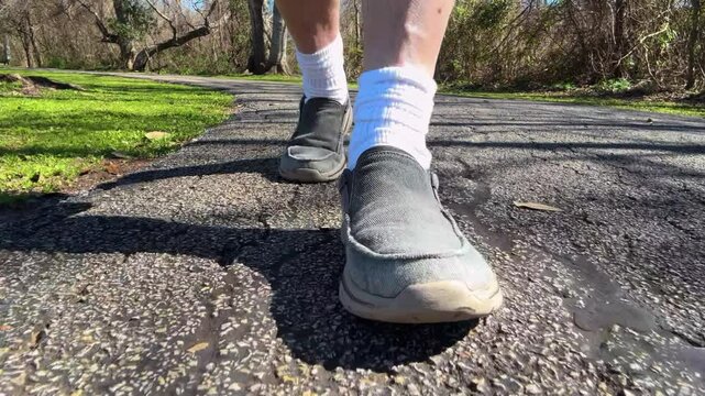 man walking in the park low angle of shoes