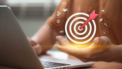 Concept of business goal setting and strategic planning as professional interacts with futuristic...