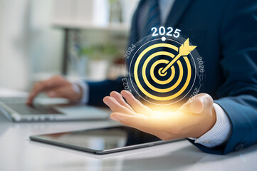 Concept of business goal setting and future success for 2025. businessman presents a glowing...