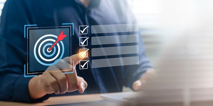 Business goal setting and task management. professional interacts with a digital checklist and target icon, representing productivity, goal achievement, and strategic planning.