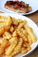 French fries on wood background
