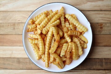 French fries on wood background
