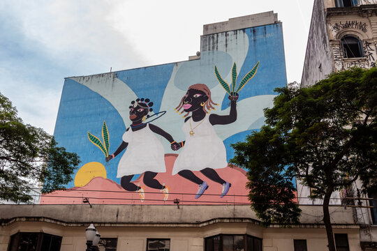 S&Atilde;O PAULO, SP, BRAZIL - JULY 27, 2024: Graffiti Pulando Vassoura de M&atilde;os Dados (Jumping Over a Broom with Hands Given) created in 2021 by artist F&aacute;bio Gon&ccedil;alves for the Street Art Museum.
