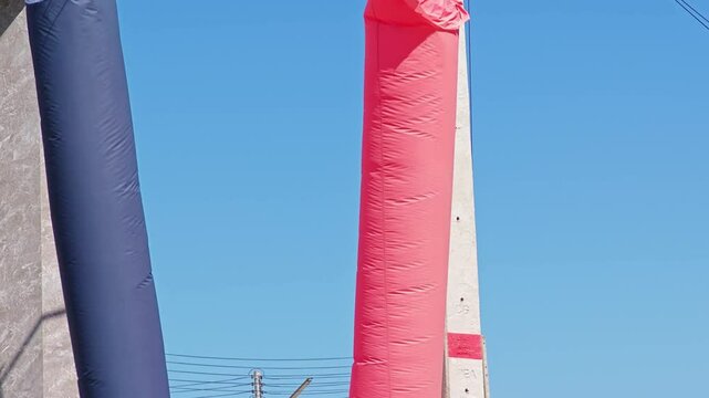 Red and blue inflatable doll blowing in the wind 