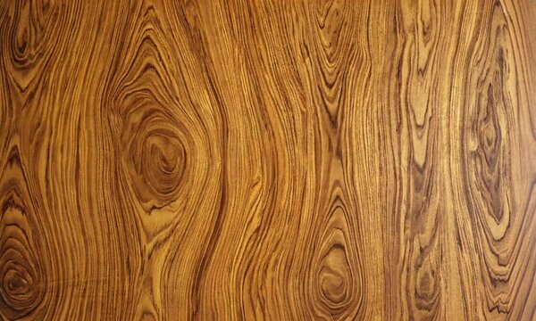 Detailed close-up of wood texture with intricate grain patterns. Perfect for design, backgrounds, woodworking, and organic materials. Ideal for rustic, natural, and decorative surface applications