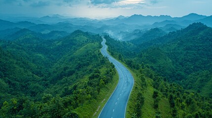 Fototapeta premium Winding Mountain Road in Lush Green Landscape Aerial View Nature Photography