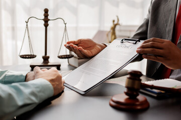 Judge gavel with Justice lawyers having team meeting at law firm background. Concepts of Law and...