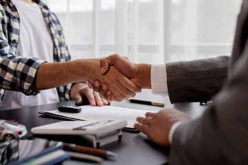 Handshake of CAR cooperation customer and salesman after agreement, successful car loan contract buying or selling new vehicle.
