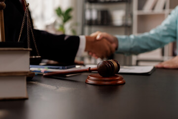 Justice Statue, Gavel, with Lawyer Handshake in Business Meeting with Scales of Justice and Gavel...
