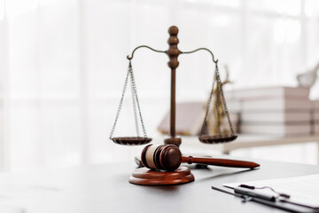 Justice statue, gavel, with LAW Justice lawyers having team meeting at law firm background....