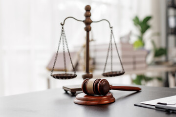 Justice statue, gavel, with LAW Justice lawyers having team meeting at law firm background....