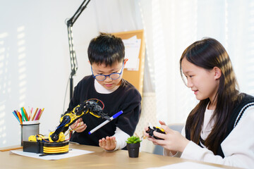 Asian boy and girl are learning with STEM toys, STEM is Sciences, Technology, Engineering, and Mathematics.