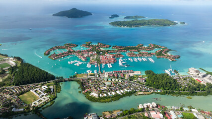 Aerial view of Eden Island's marinas filled with boats, clear blue waters under a bright sky....